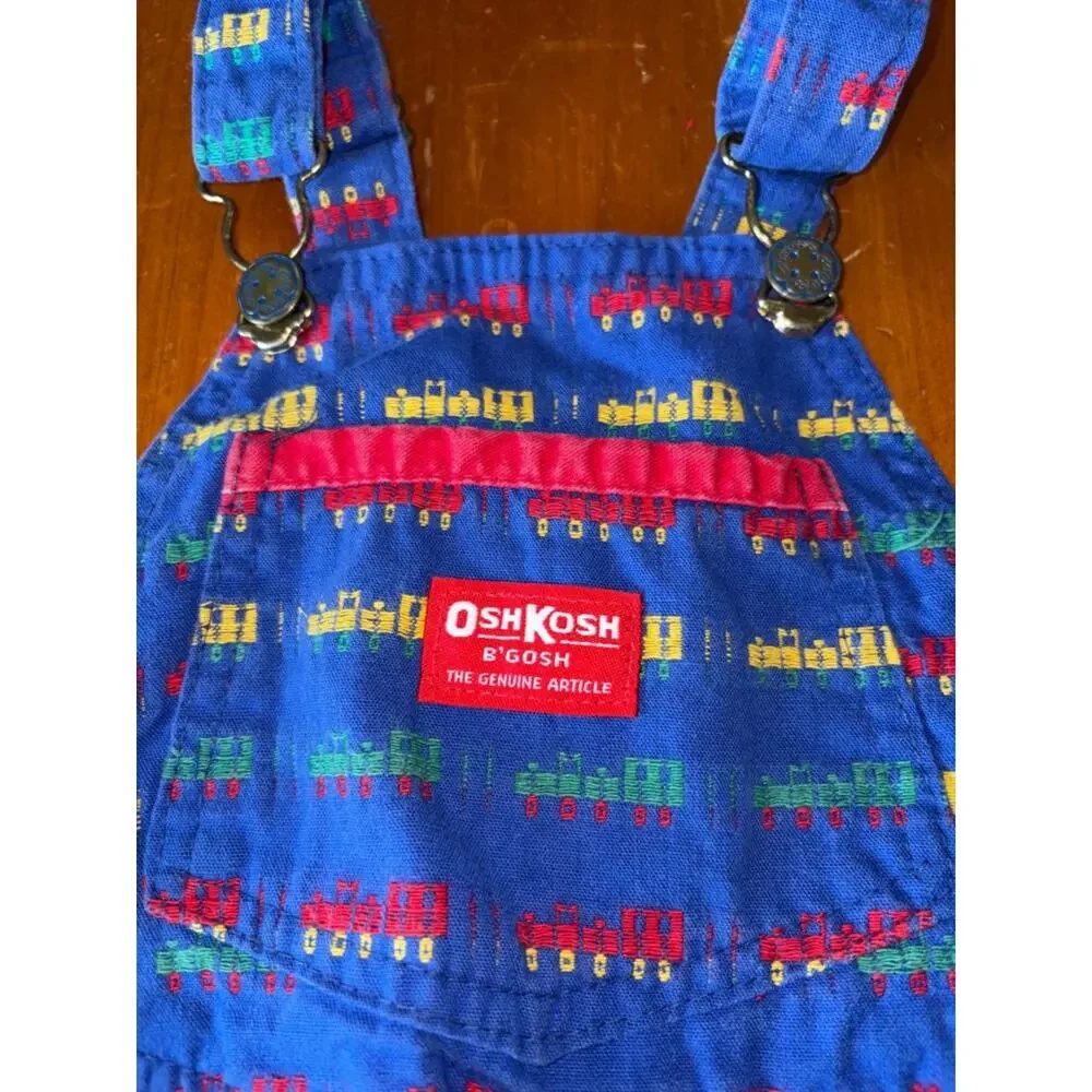 OshKosh B'gosh Bright Blue Overalls with Red, Yellow and Green Train Print